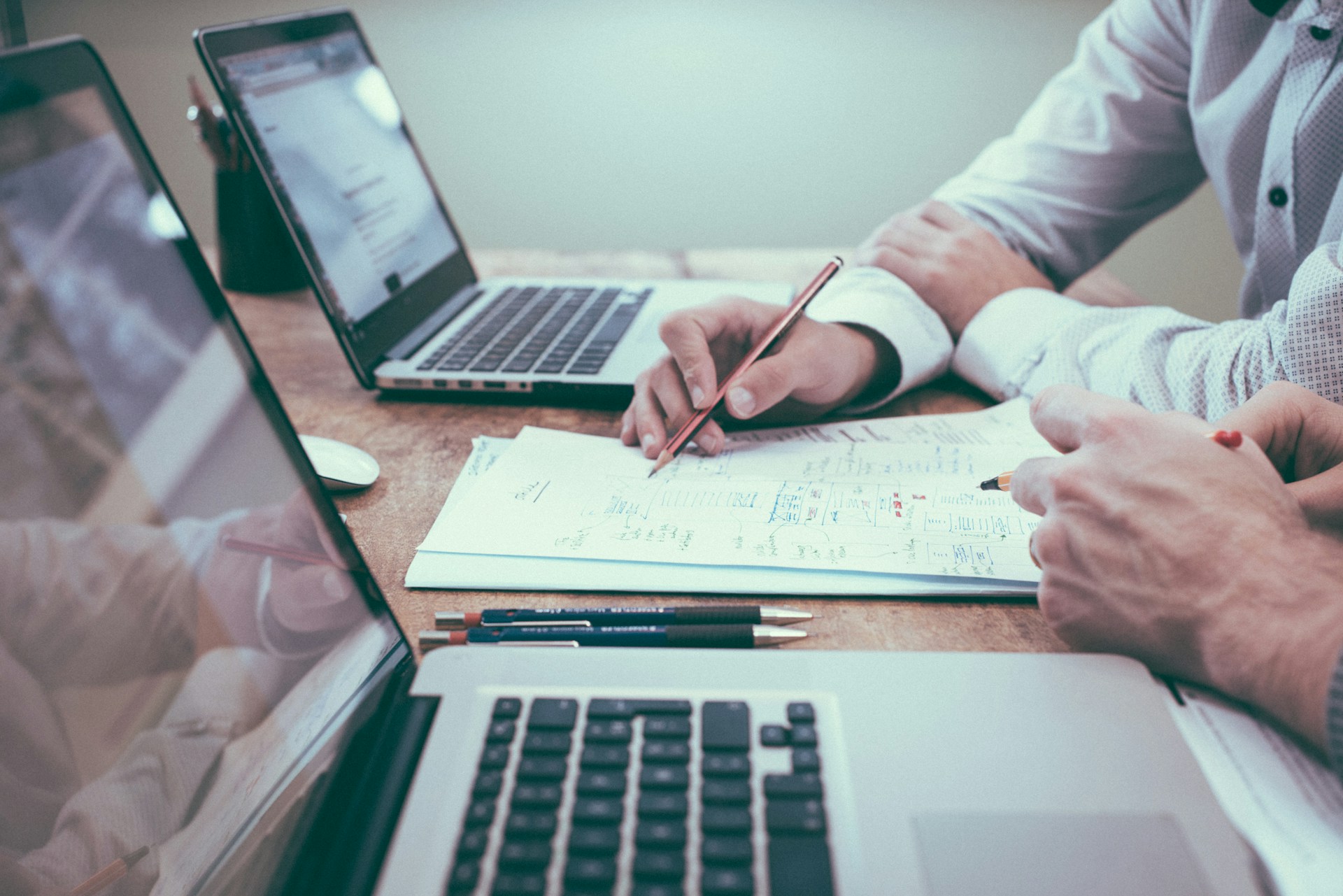 Planning desk with blueprint worksheets and scenario grid notes for financial modules